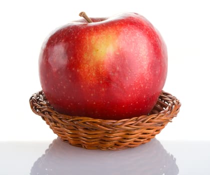 close-up red apple in basket with reflection, isolated on white