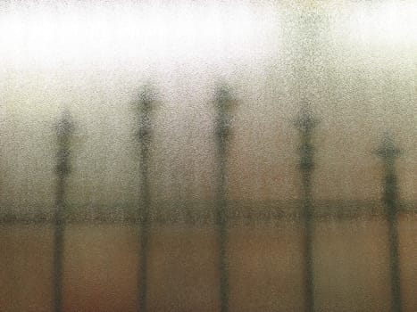 fence through a frosted glass