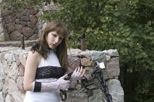 young women in white dress with black lace play with big chain