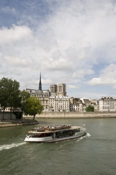 seine river, barge, and notre dame in background