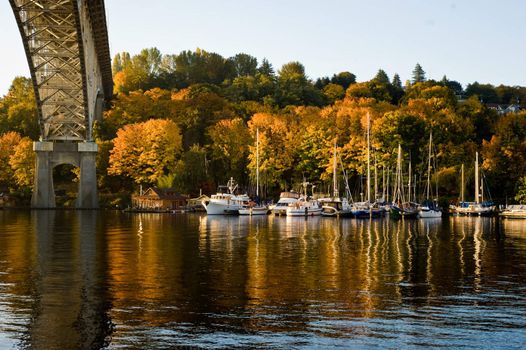 looking across lake to part of bridge and house boat