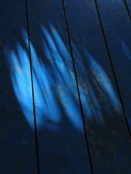 light and shadow on a blue floor