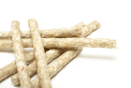 A pile of raw hide sticks to treat the dog daily.