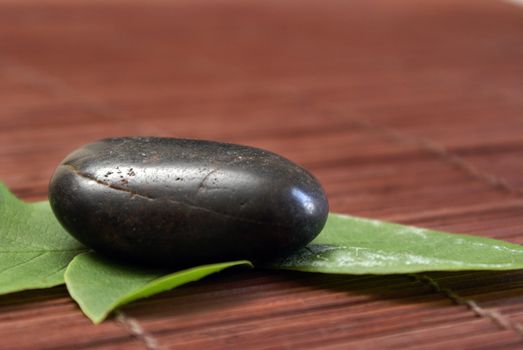 A pebble and leaves give a natural tranquil scene realting to feng shui.