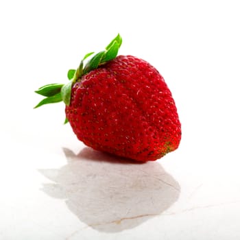 Delicious strawberry isolated on white with a marble base in high key