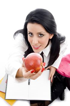 student holding an apple against white background