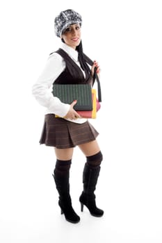 student with her books and school bag on an isolated white background