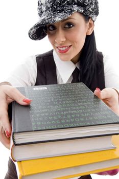student in cap holding stack of books against white background