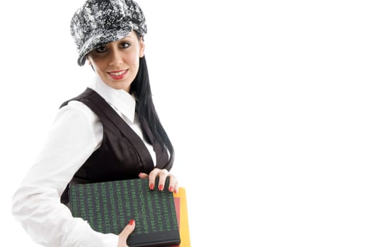 female student wearing cap holding books  against white background