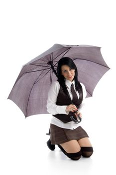 young female kneeling down on floor holding umbrella against white background