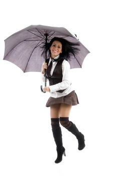 young woman jumping holding an umbrella on an isolated white background