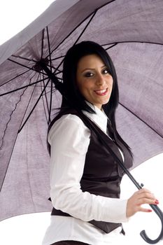 portrait of caucasian model smiling and holding an umbrella against white background