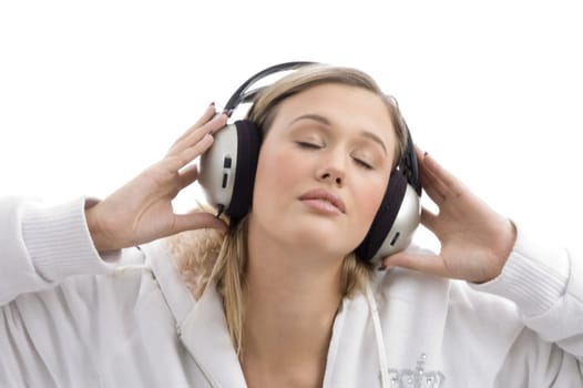 woman listening to music with closed eyes on an isolated white background