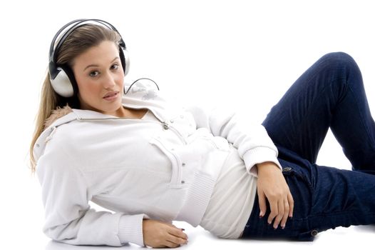 young model listening music with headphones against white background