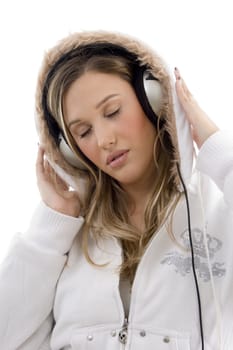 young woman enjoying music with headphones on an isolated white background