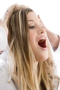 close up view of happy female holding her jacket cap on her head with white background