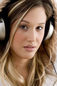 young woman enjoying music with headphones on an isolated white background