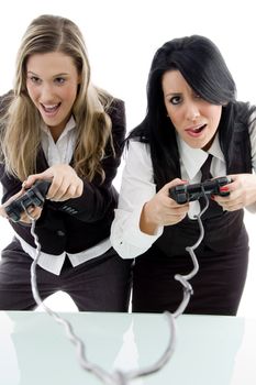 female partners playing game and holding remote against white background