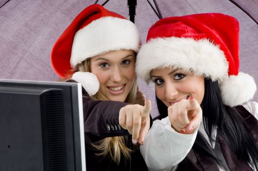 colleagues wearing christmas hat and pointing 