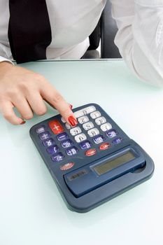 close up of finger on calculator on an isolated background