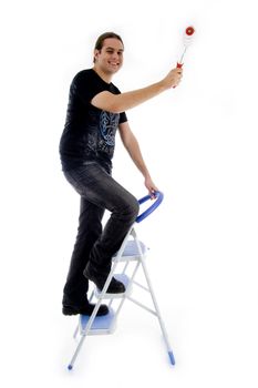 young painter standing on ladder with an isolated background