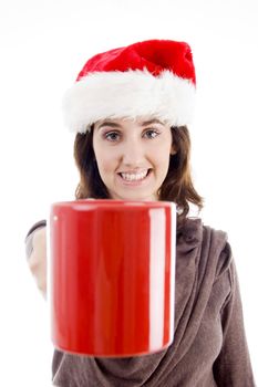 female in christmas hat showing her coffee mug  isolated on white background