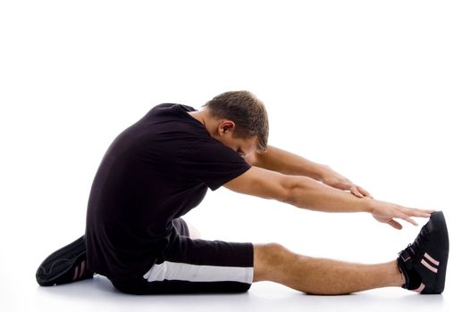 muscular guy stretching his legs and hands on an isolated background