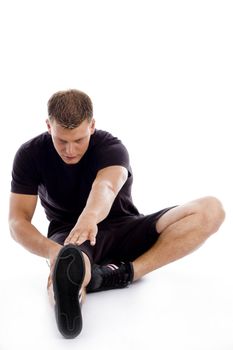 muscular man stretching his legs with white background