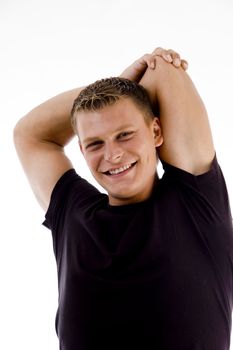 posing handsome muscular man stretching with white background
