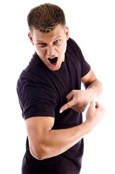 shouting man pointing at his muscles against white background