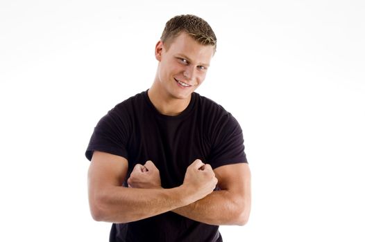 smiling young man showing his muscles on an isolated background