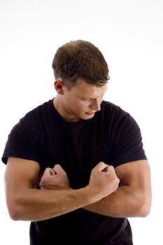 young man showing his muscles against white background