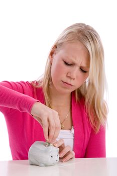 Pretty young teenager trying to put money in her piggybank