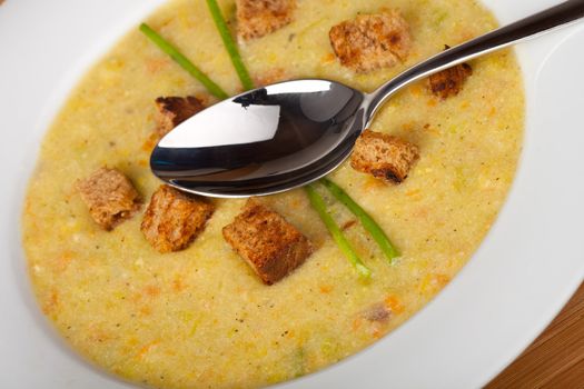 potato soup with croutons and chive strands