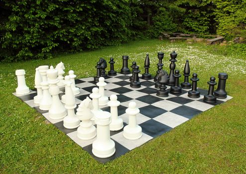 big outdoor chess in green lawn in sunny day