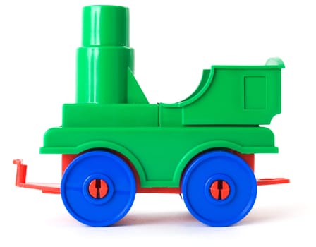 Toy plastic green engine on the white background