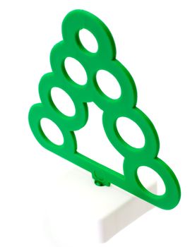 Toy plastic green tree on the white background