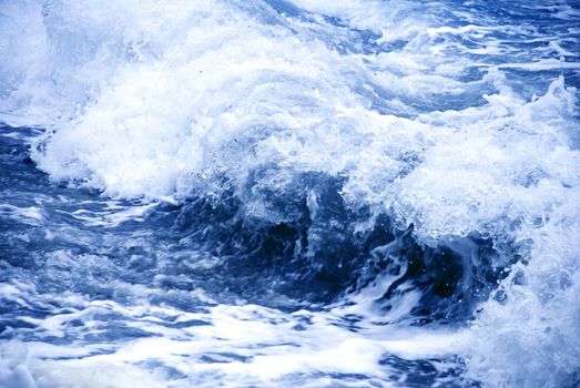 big storm wave formation over blue water