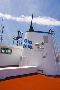 a radar and weather instruments on the upper dek of a ship