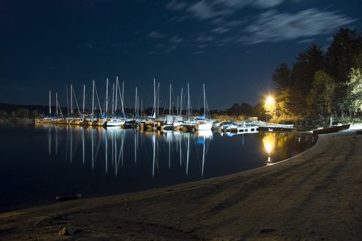 many boats docked during night at a local marina