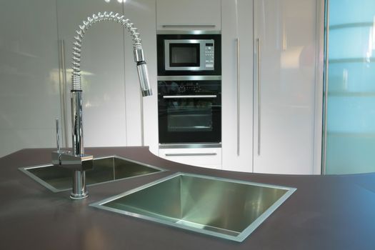 modern metallic sink with graceful tap on the super-modern kitchen