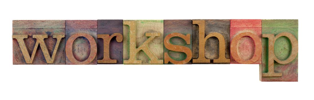 the word workshop in vintage wood letterpress type blocks, stained by color ink, isolated on white