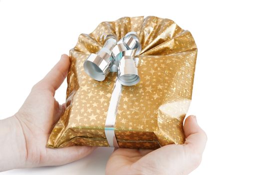 golden gift box with silver ribbon keeping in hands isolated on white background with clipping path