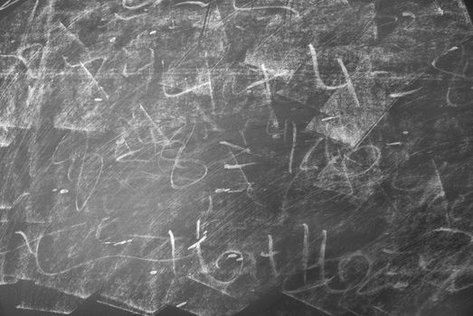 A macro shot of a messy chalkboard.