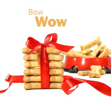 Dog biscuits  wrapped with red bow on white background