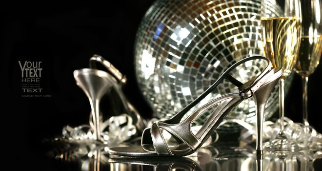 Silver party shoes with champagne glasses against a party background