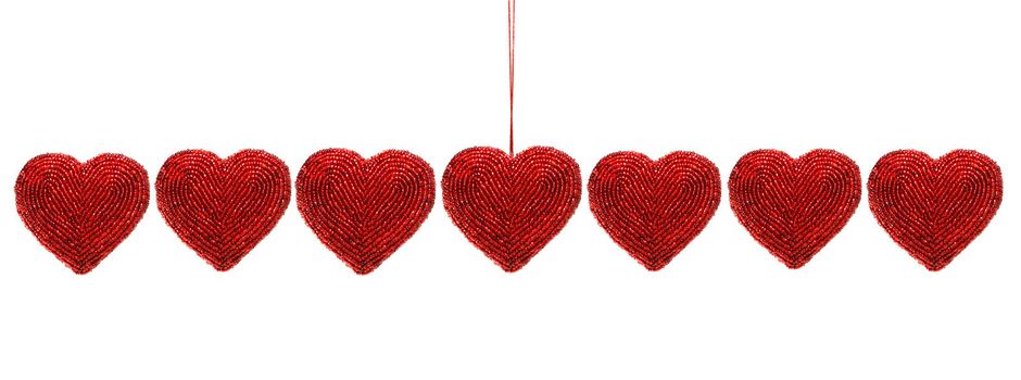 Red beaded hearts isolated against white background