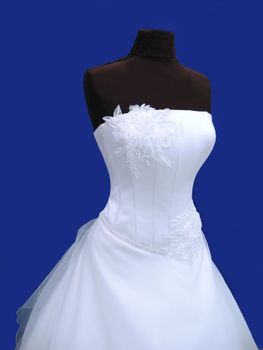 white wedding dress on dummy isolated on blue
