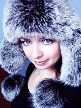 beautiful woman in fur hat blue toned