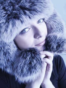 lovely woman in winter fur hat blue toned
